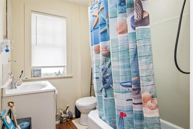 full bath with toilet, shower / bath combo, and vanity