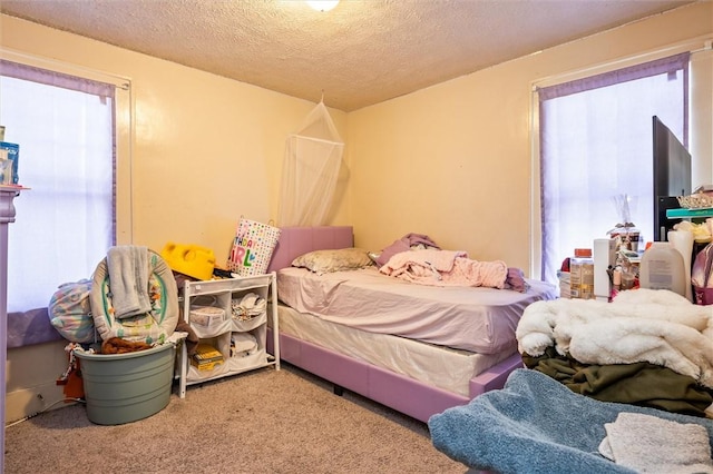 bedroom with carpet and a textured ceiling