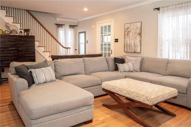 living area with light wood finished floors, stairway, crown molding, and recessed lighting