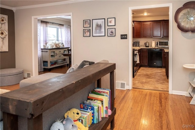 hallway featuring ornamental molding, light wood-type flooring, a toaster, and visible vents