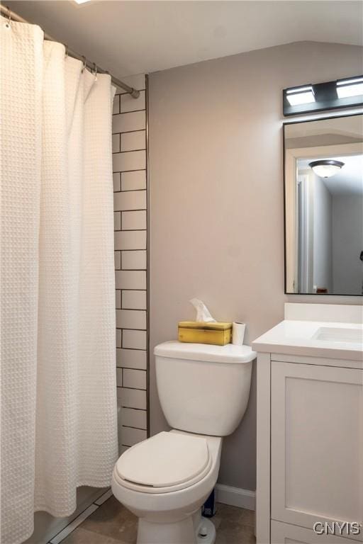 bathroom featuring toilet, shower / tub combo, tile patterned floors, and vanity