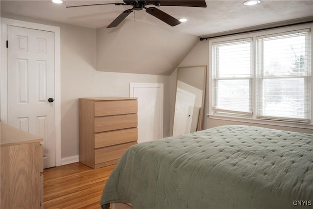 bedroom featuring recessed lighting, light wood-style flooring, a ceiling fan, vaulted ceiling, and baseboards