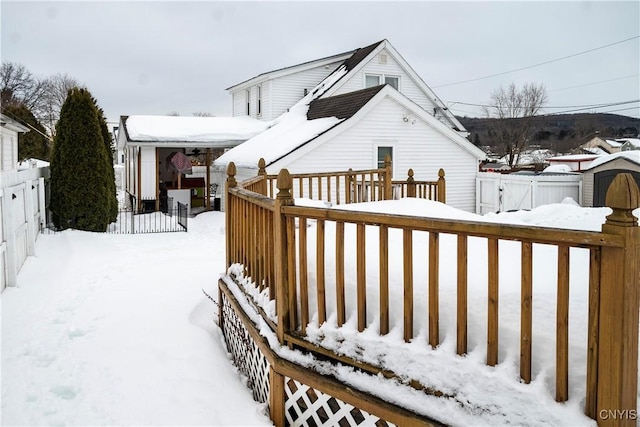 snow covered deck with fence