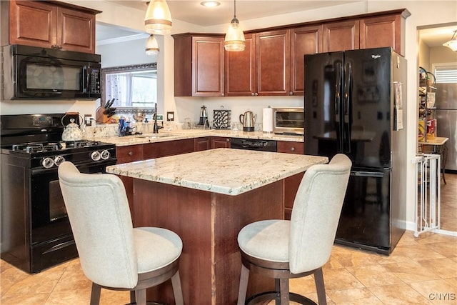 kitchen featuring a breakfast bar area, a center island, decorative light fixtures, black appliances, and a sink