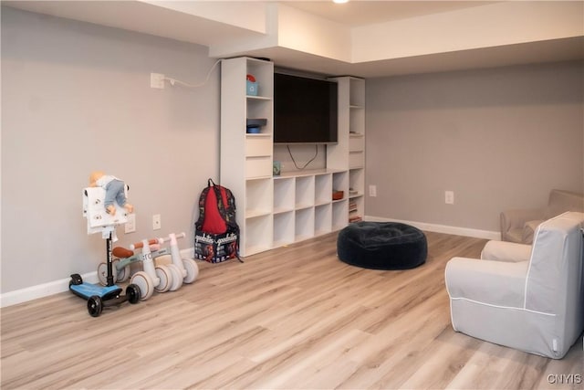 sitting room featuring baseboards and wood finished floors