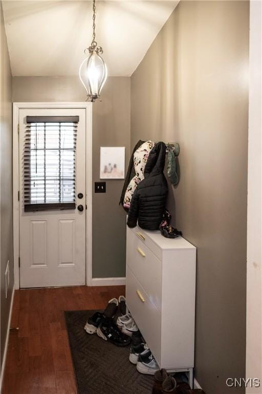 entryway with a chandelier and dark wood-style flooring