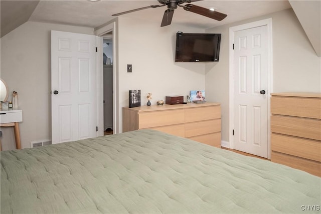 bedroom featuring ceiling fan, visible vents, and vaulted ceiling