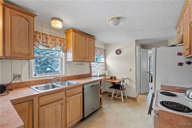 kitchen featuring white appliances, light countertops, a textured ceiling, light floors, and a sink