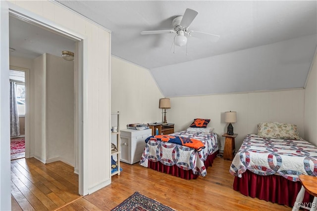 bedroom featuring vaulted ceiling, ceiling fan, and light wood-type flooring