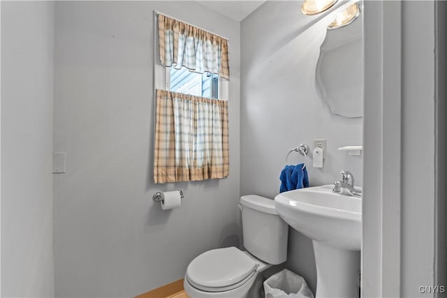 half bath with toilet and a sink