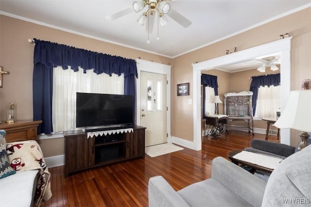 living room with ornamental molding, dark wood-style flooring, a ceiling fan, and baseboards