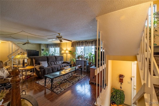 living room featuring a textured ceiling, wood finished floors, and a ceiling fan