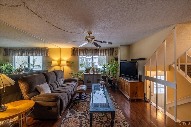 living room featuring a wealth of natural light, a ceiling fan, and wood finished floors