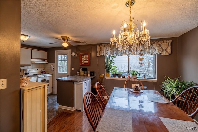 dining area featuring dark wood-type flooring, a textured ceiling, and a ceiling fan