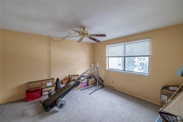 exercise room featuring a textured ceiling, carpet, and baseboards