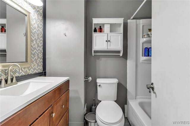 bathroom featuring toilet, tasteful backsplash, and vanity