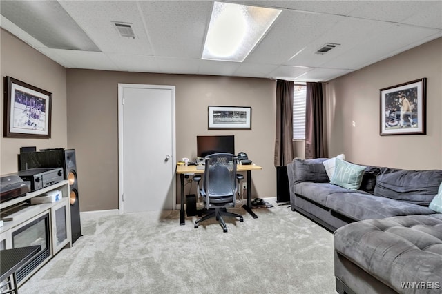 office space with a drop ceiling, carpet flooring, visible vents, and baseboards