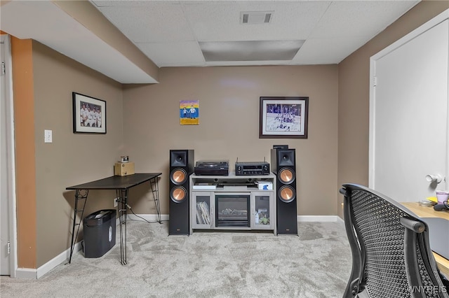 home office with light colored carpet, visible vents, a drop ceiling, and baseboards