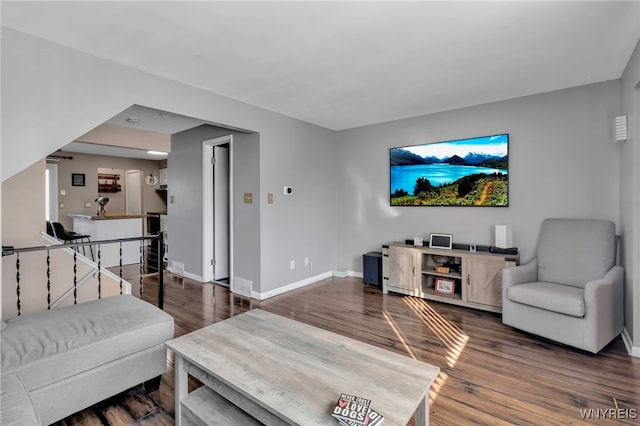 living area featuring dark wood finished floors and baseboards