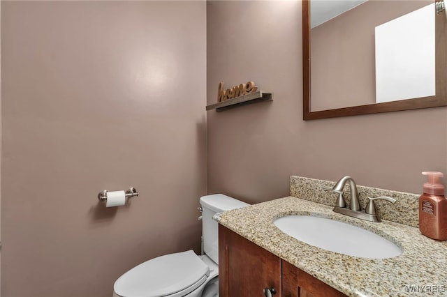 bathroom with toilet and vanity