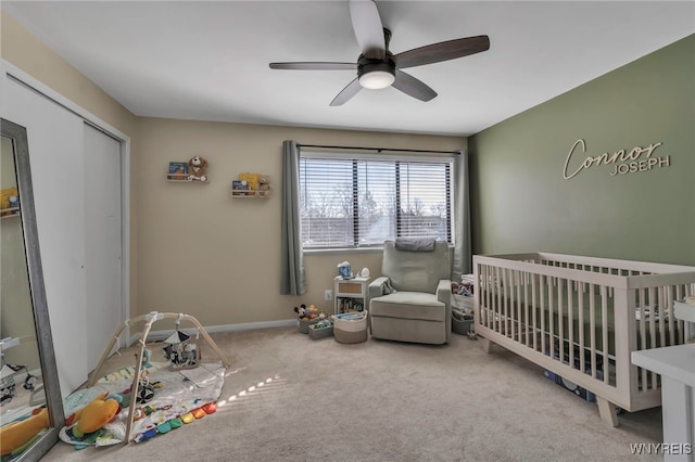 carpeted bedroom featuring ceiling fan, a closet, and baseboards