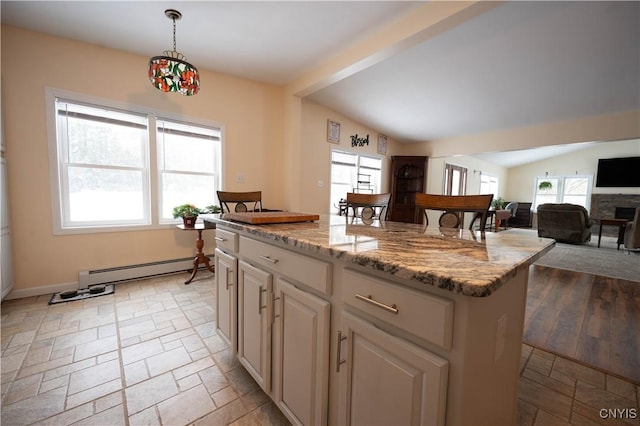 kitchen featuring decorative light fixtures, lofted ceiling, baseboard heating, open floor plan, and a kitchen island