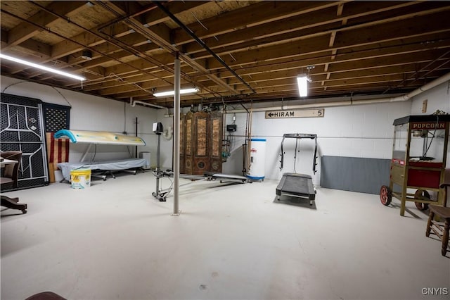 unfinished basement with water heater and concrete block wall