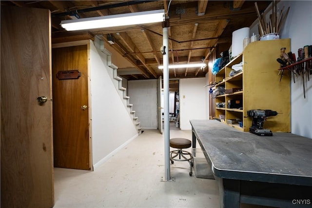 unfinished basement featuring stairway