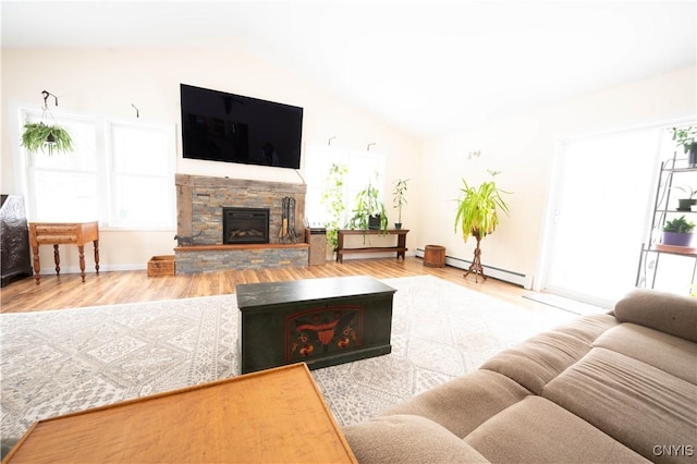 living room with vaulted ceiling, a fireplace, baseboard heating, and wood finished floors