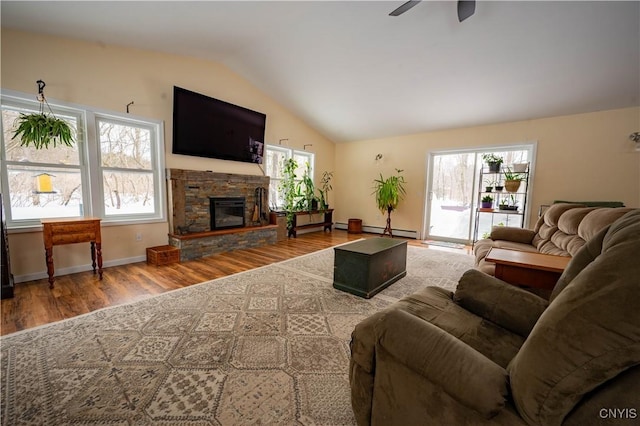 living area with lofted ceiling, wood finished floors, and a wealth of natural light