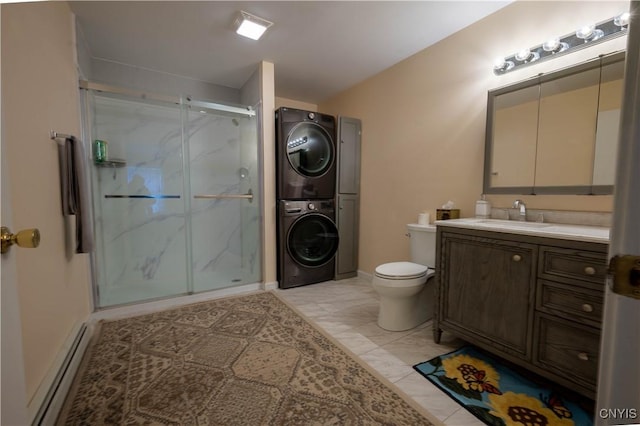 full bathroom with a baseboard radiator, vanity, marble finish floor, stacked washing maching and dryer, and a marble finish shower