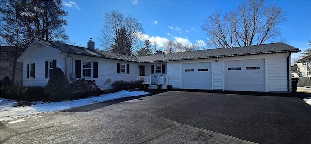 ranch-style house with a garage, driveway, and a chimney