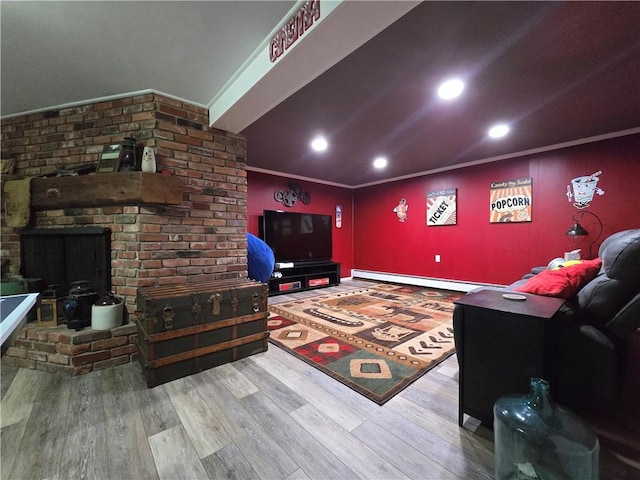 living area featuring ornamental molding, baseboard heating, wood finished floors, and recessed lighting