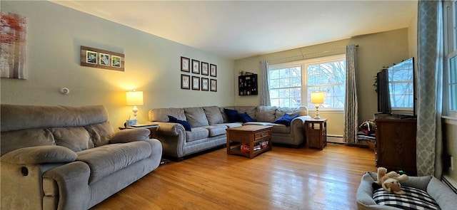 living area featuring a baseboard radiator and light wood-style flooring