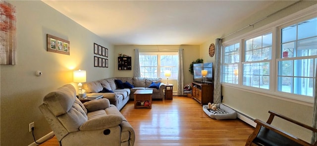 living room with light wood finished floors and a baseboard radiator