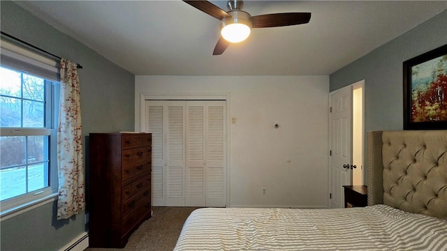 carpeted bedroom featuring a ceiling fan, baseboard heating, and a closet