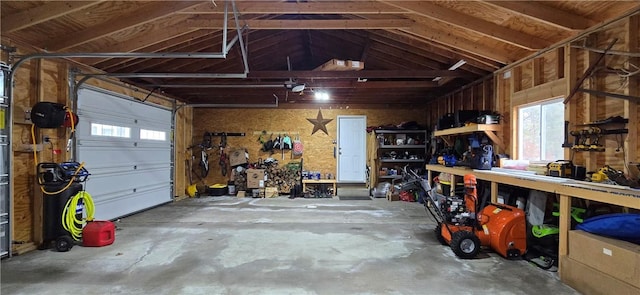 garage with a workshop area and a garage door opener