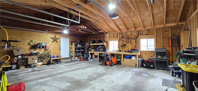 garage featuring a garage door opener and a workshop area