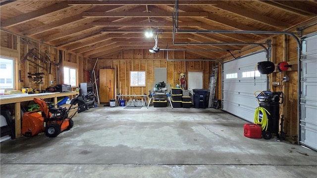 garage with a workshop area and a garage door opener