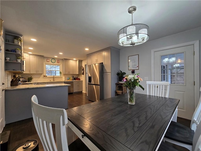 dining room with dark wood-style floors, a chandelier, and recessed lighting