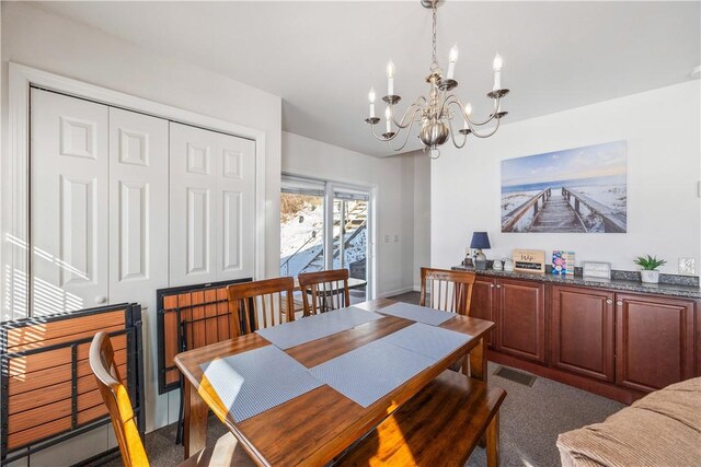 dining area featuring visible vents and an inviting chandelier