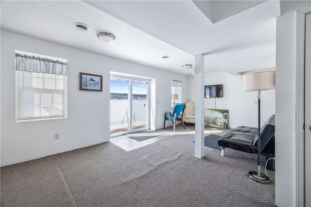 interior space featuring visible vents and carpet flooring