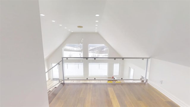 bonus room with lofted ceiling, baseboards, light wood finished floors, and recessed lighting