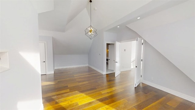 additional living space with lofted ceiling, a notable chandelier, recessed lighting, baseboards, and dark wood-style floors