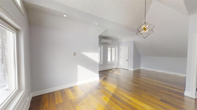 bonus room featuring dark wood-style floors, lofted ceiling, a wall mounted air conditioner, and baseboards