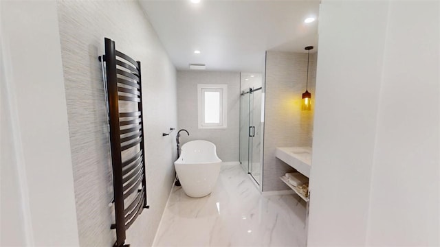 bathroom with marble finish floor, a shower stall, a freestanding bath, and recessed lighting