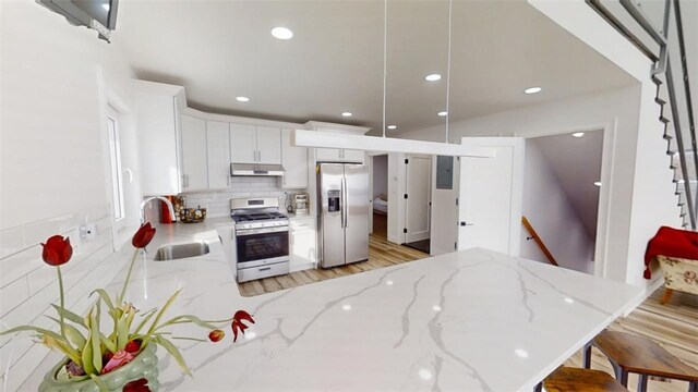 274 Reservoir Hill Rd, Plymouth, NY 13815 - kitchen with stainless steel appliances, a peninsula, light stone counters, decorative backsplash, and recessed lighting