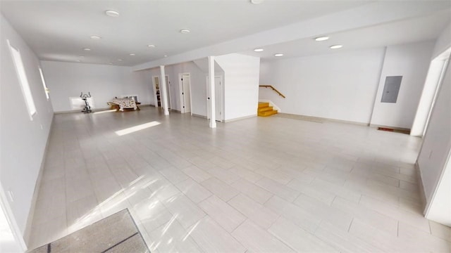 basement featuring stairs, recessed lighting, and baseboards