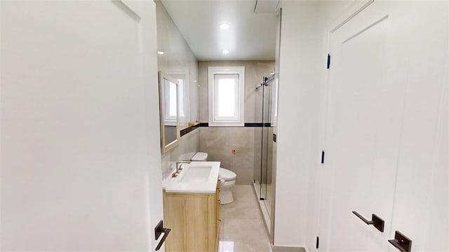 bathroom with toilet, a shower stall, tile patterned flooring, and vanity