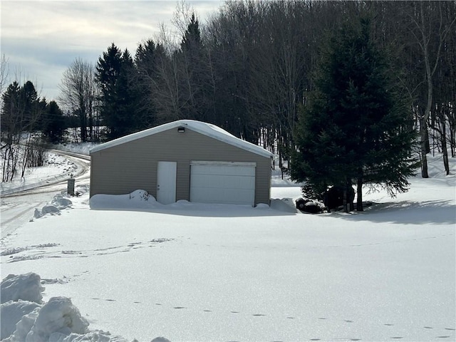 snow covered garage with a garage